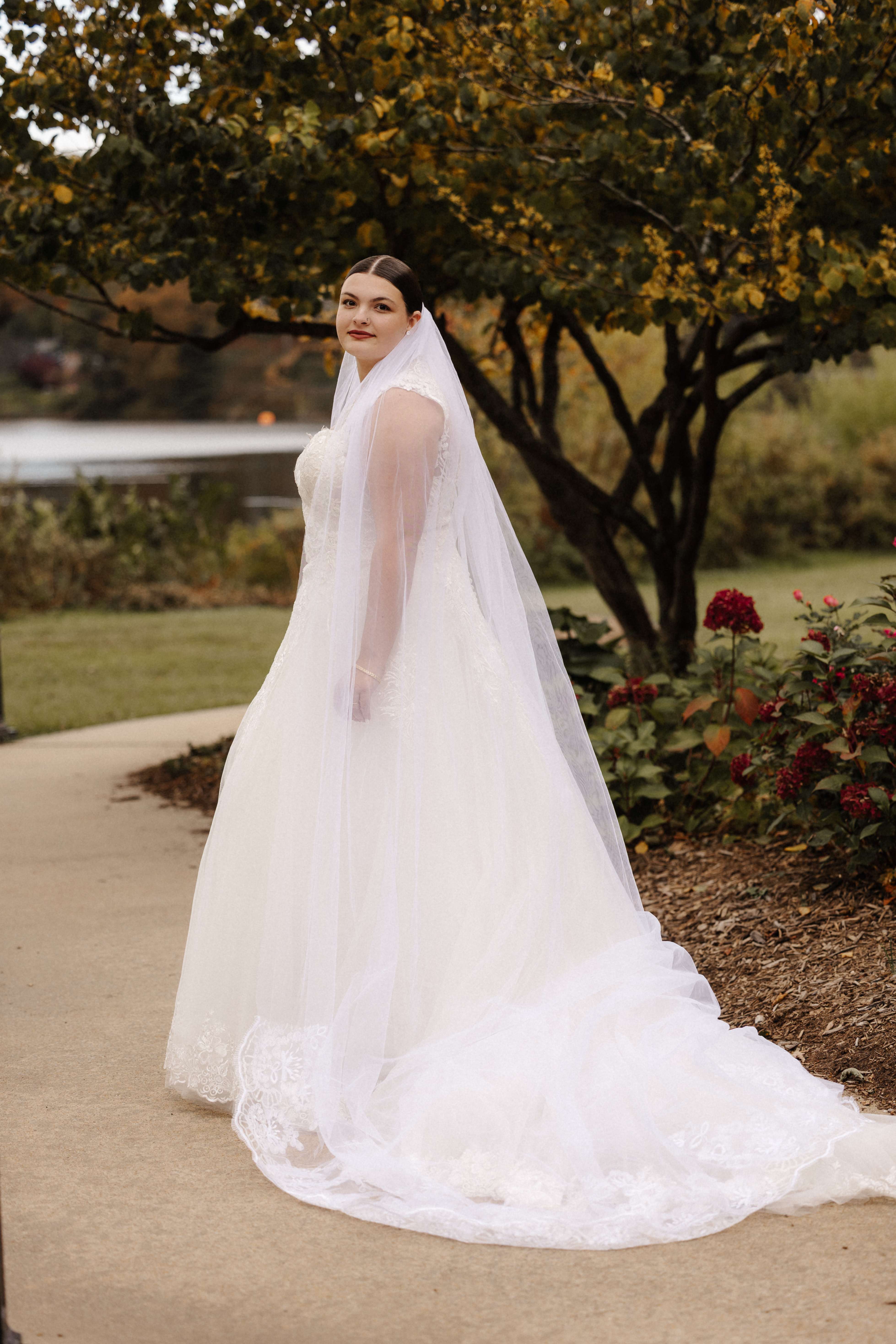 Bride solo portrait from behind showing dress train and cathedral veil