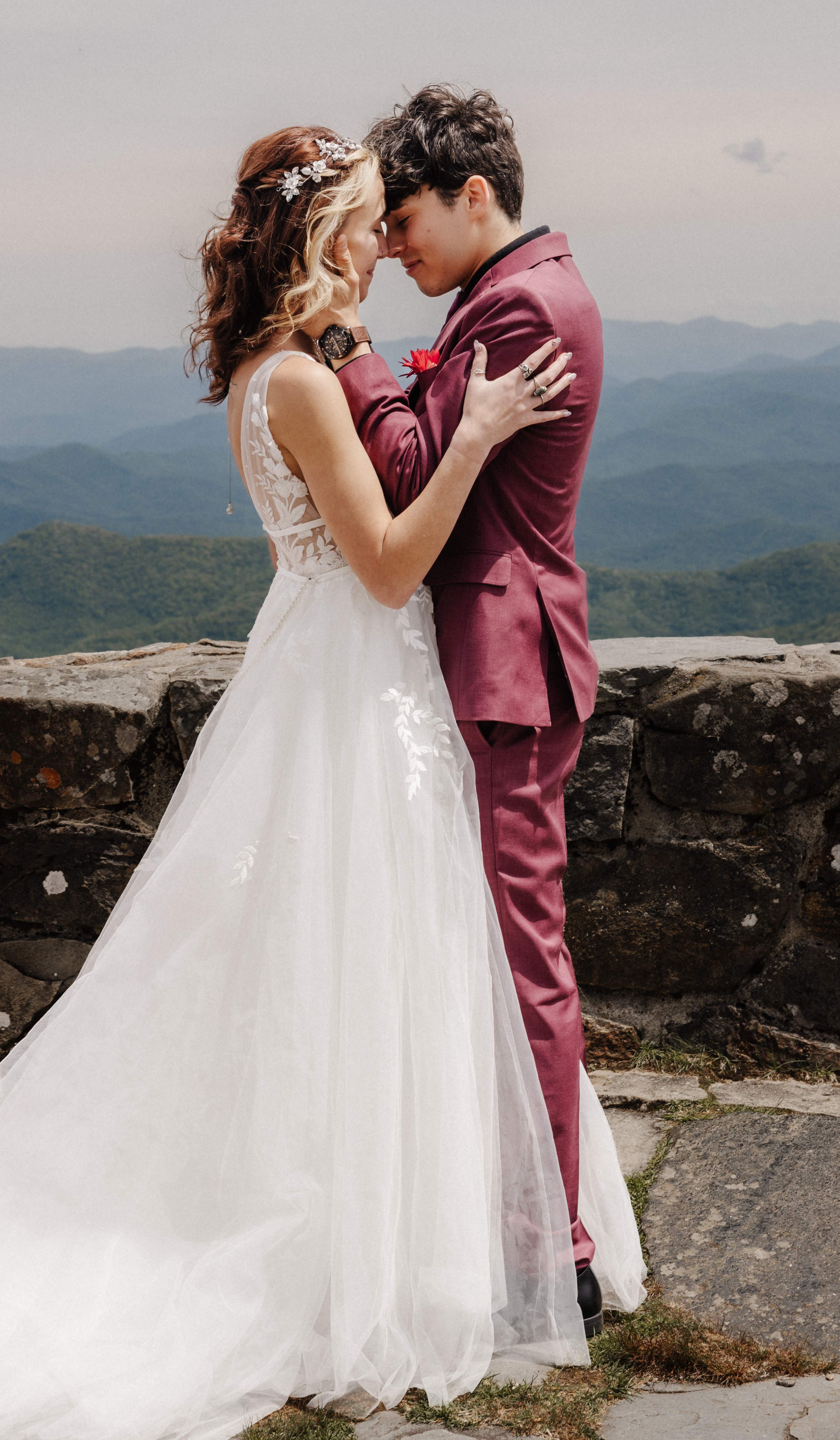Intimate couple portrait with foreheads together and mountain views