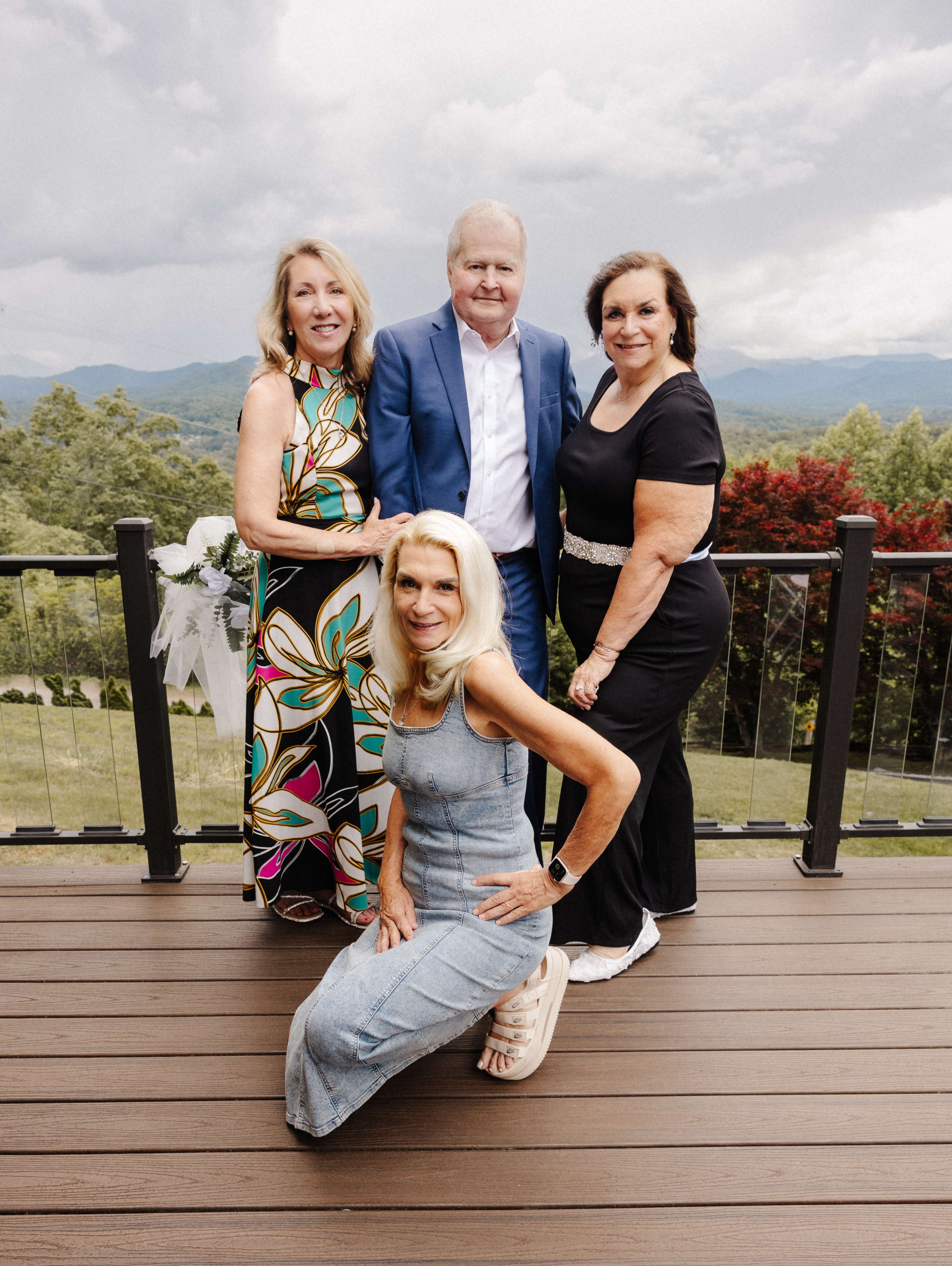 Family group portrait on deck with mountain views