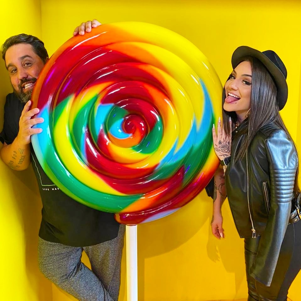 Homem e mulher com pirulito gigante