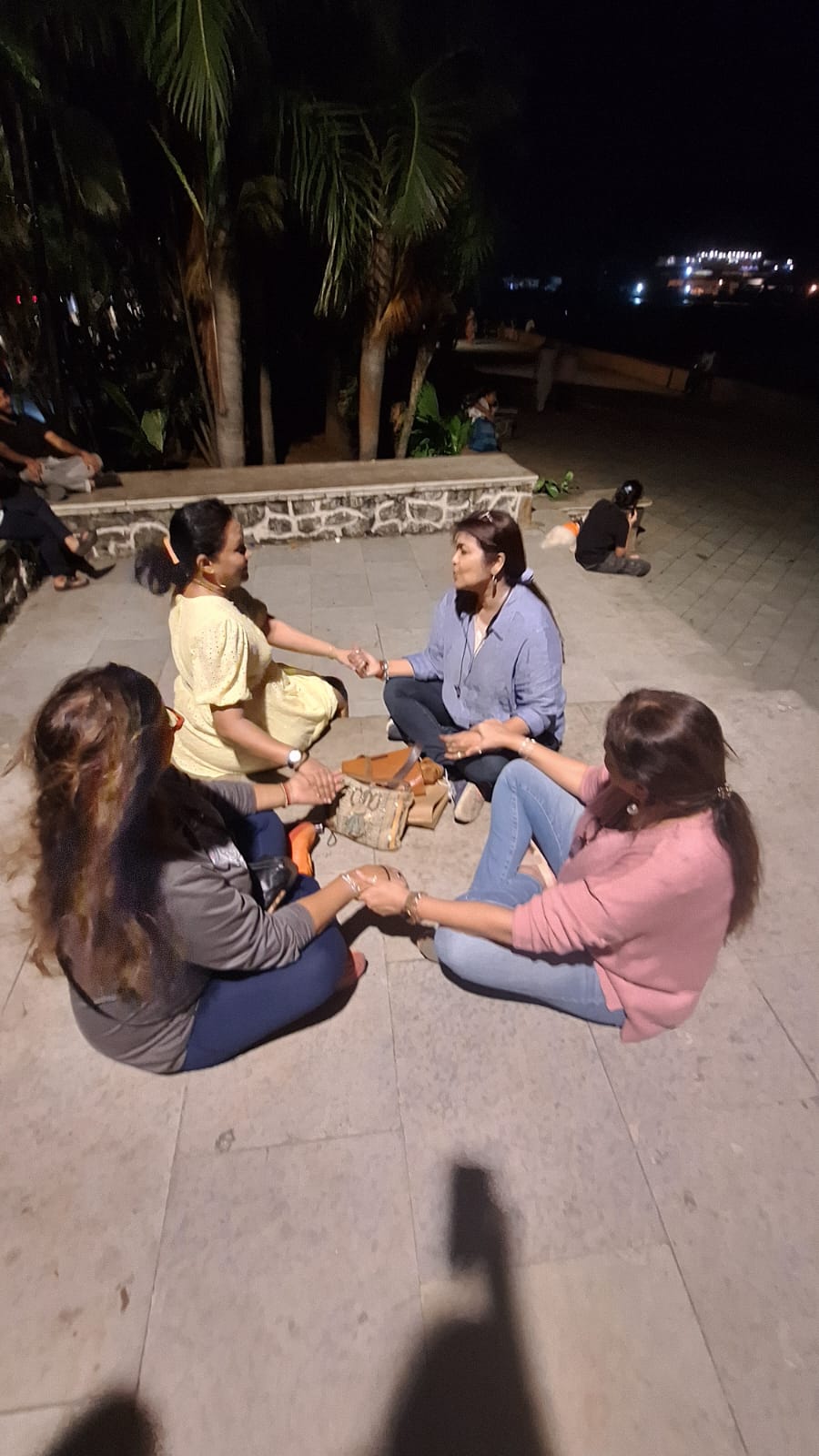 Evening group circle session with hands joined
