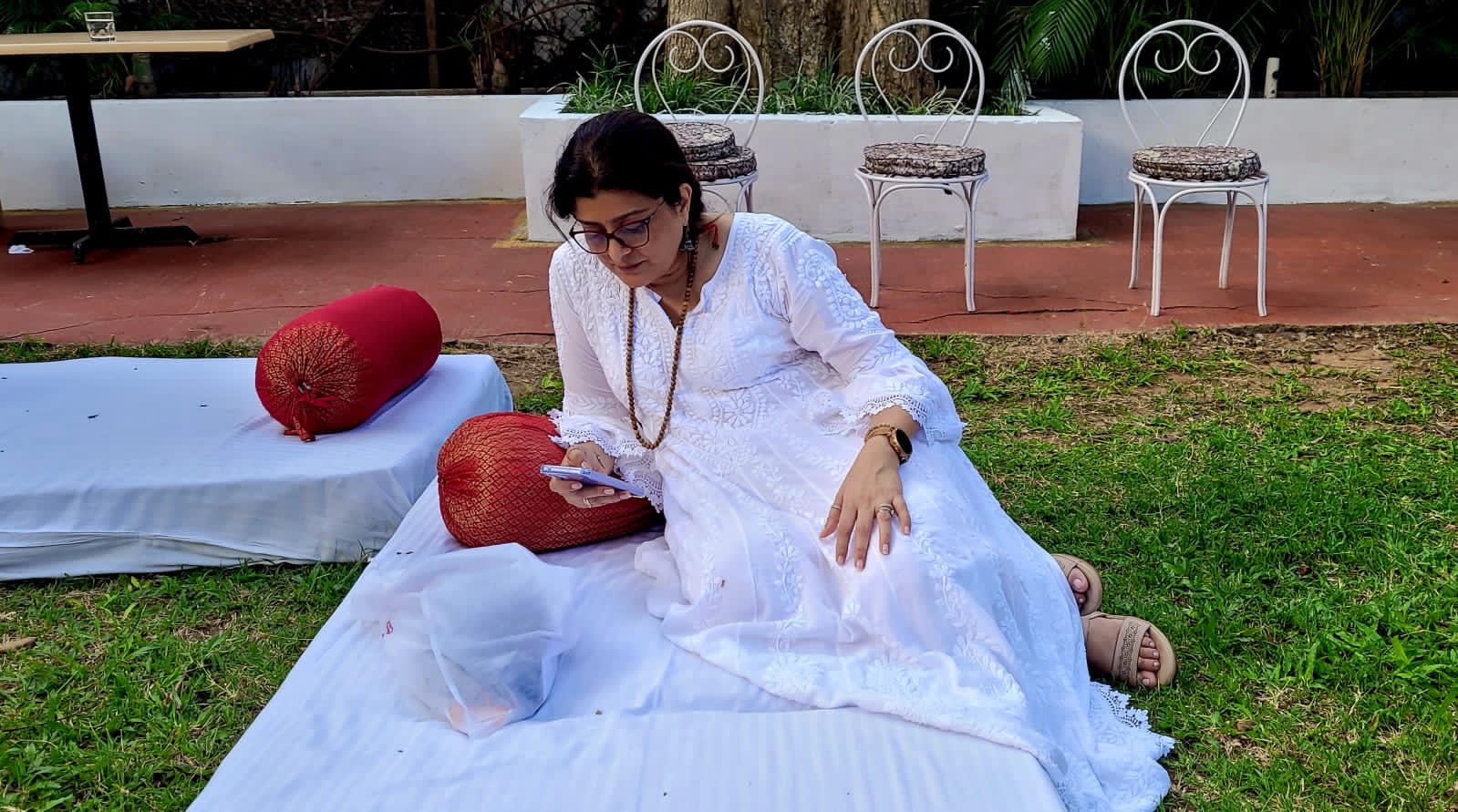 Peaceful outdoor session on grass with red cushions