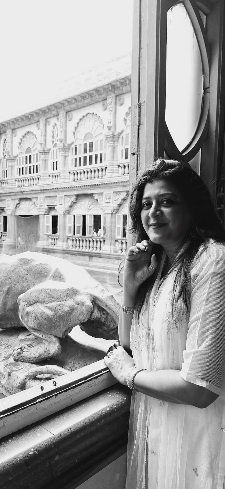 Artistic black and white portrait by historic window