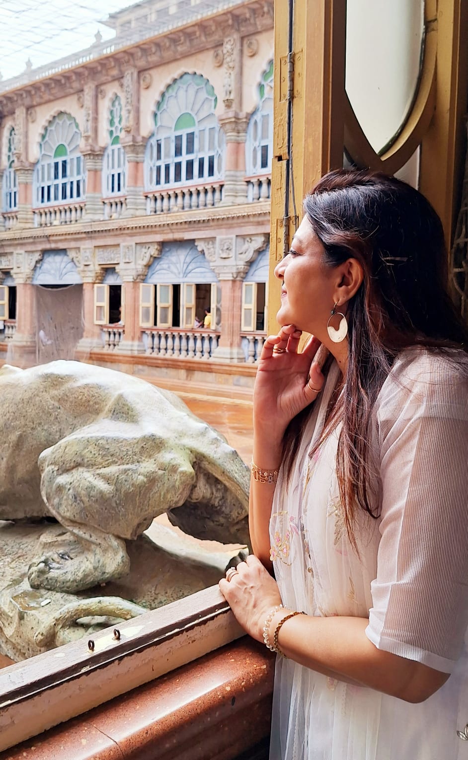 Contemplative moment by palace window with Rajasthani architecture
