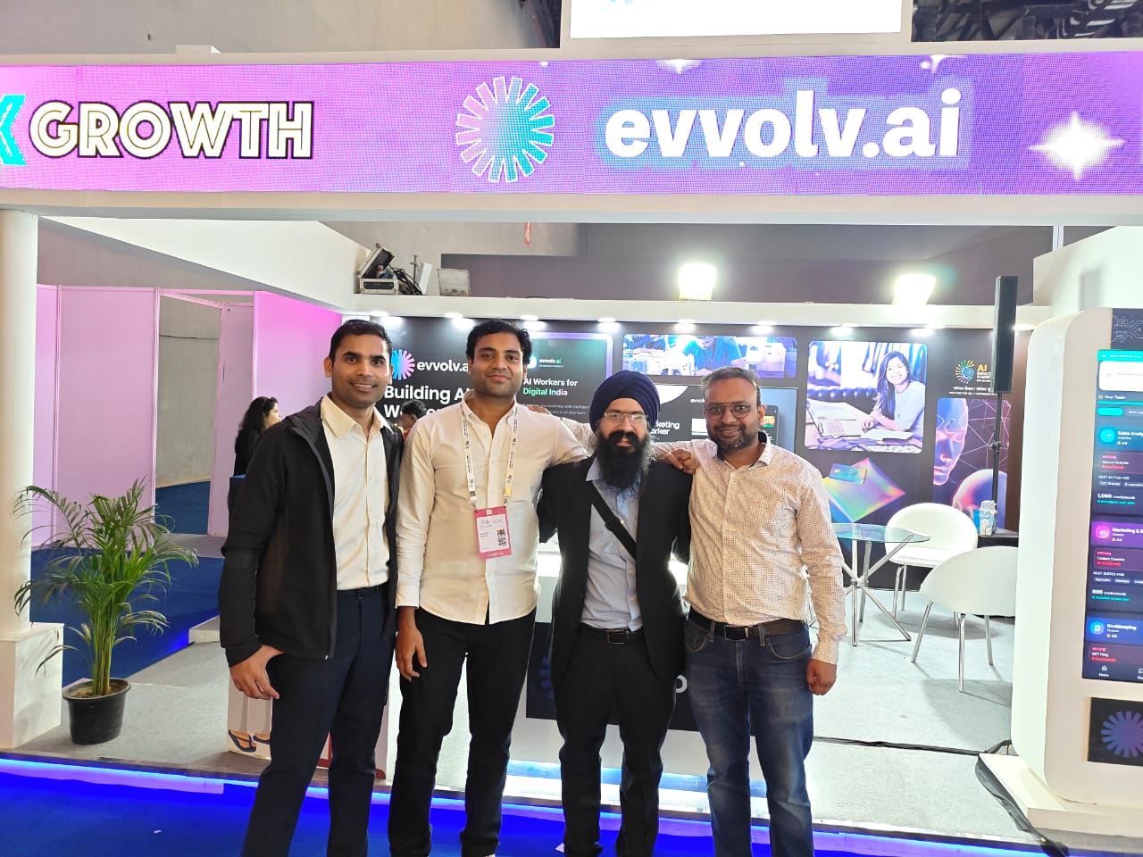 Team at evvolv.ai booth with visitors