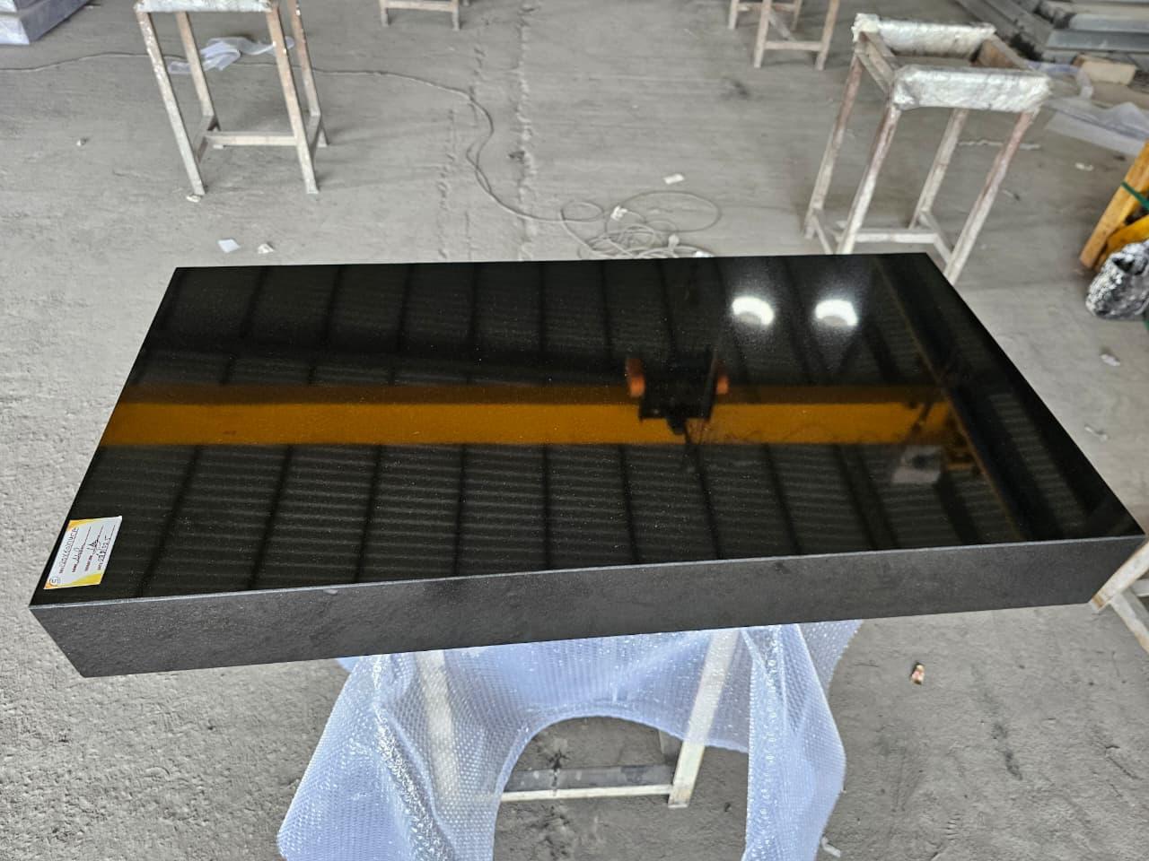 Polished black granite slab with mirror finish
