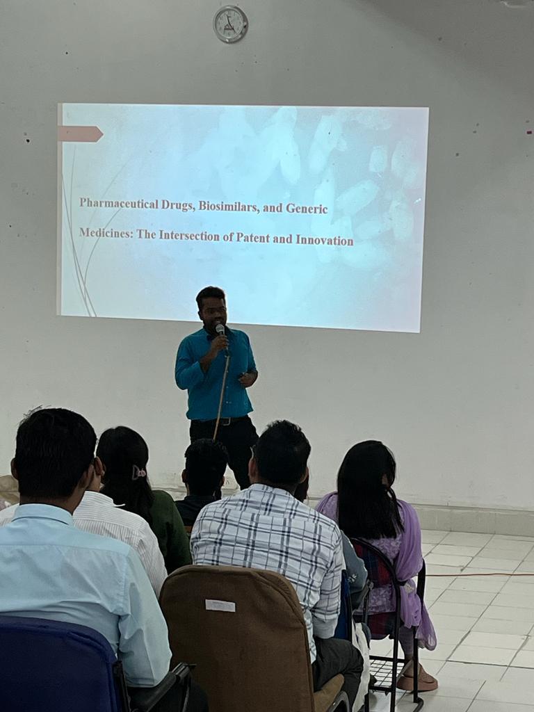 Dr. Umeshkumar KU speaking on pharmaceutical drugs, biosimilars and generic medicines to a seated audience