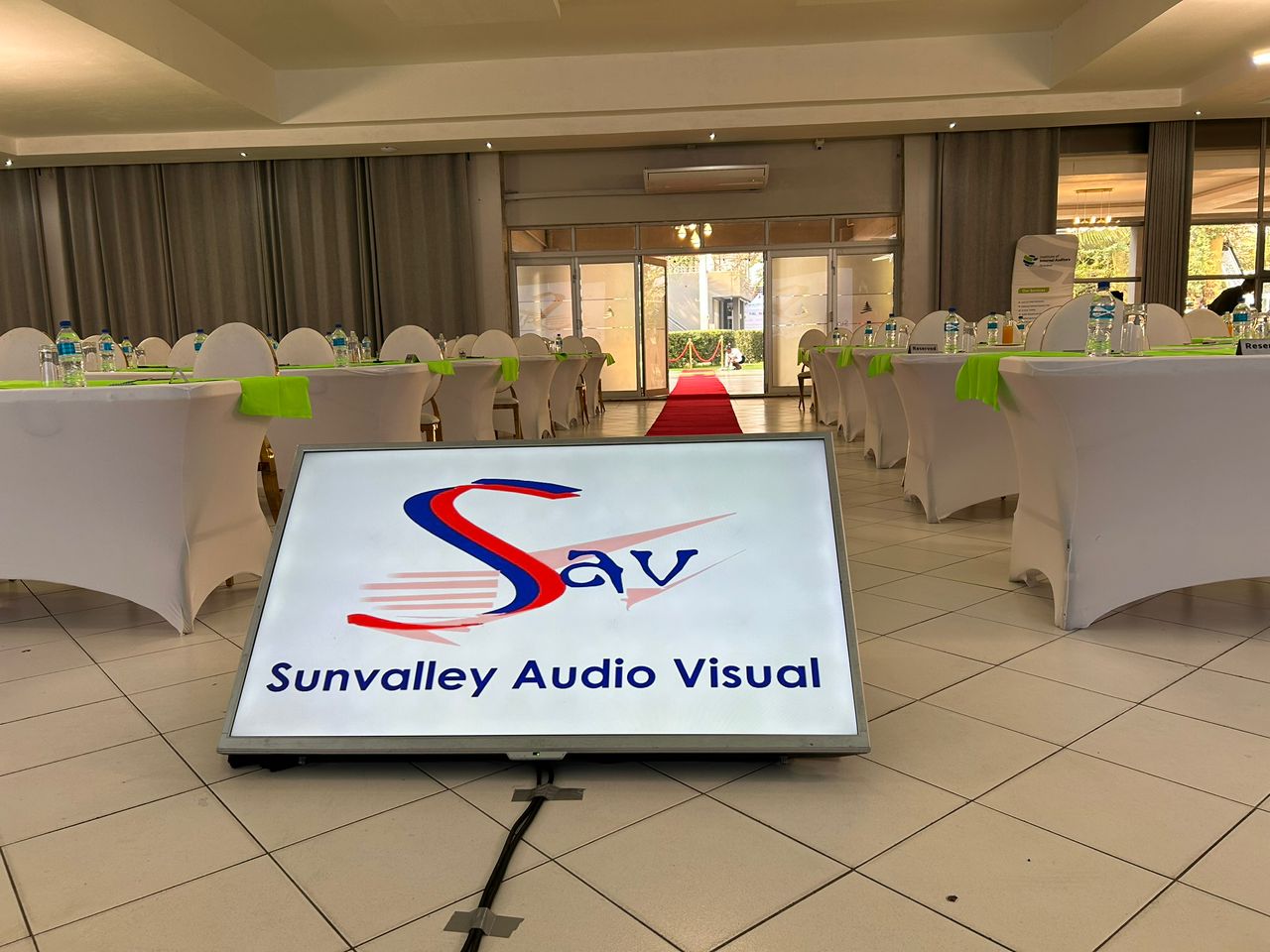 Professional event venue with Sunvalley Audio Visual branding display and elegant setup
