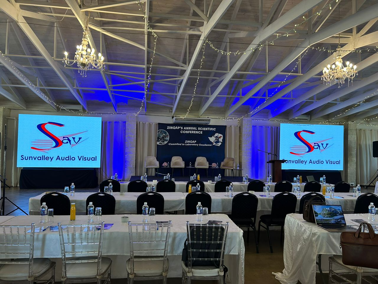 ZINQAP Annual Scientific Conference with dual LCD screens displaying Sunvalley Audio Visual branding and blue ambient lighting