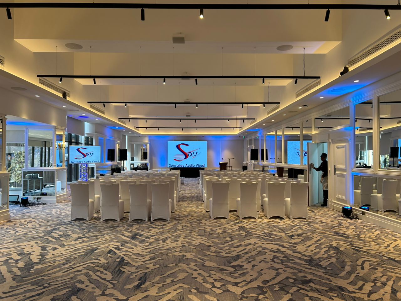 Professional indoor event venue with blue ambient lighting and Sunvalley branding