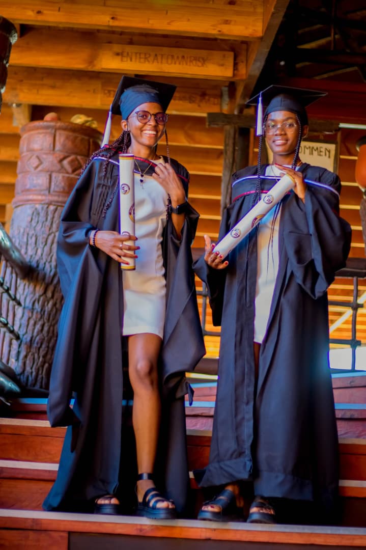 Two graduates with diplomas