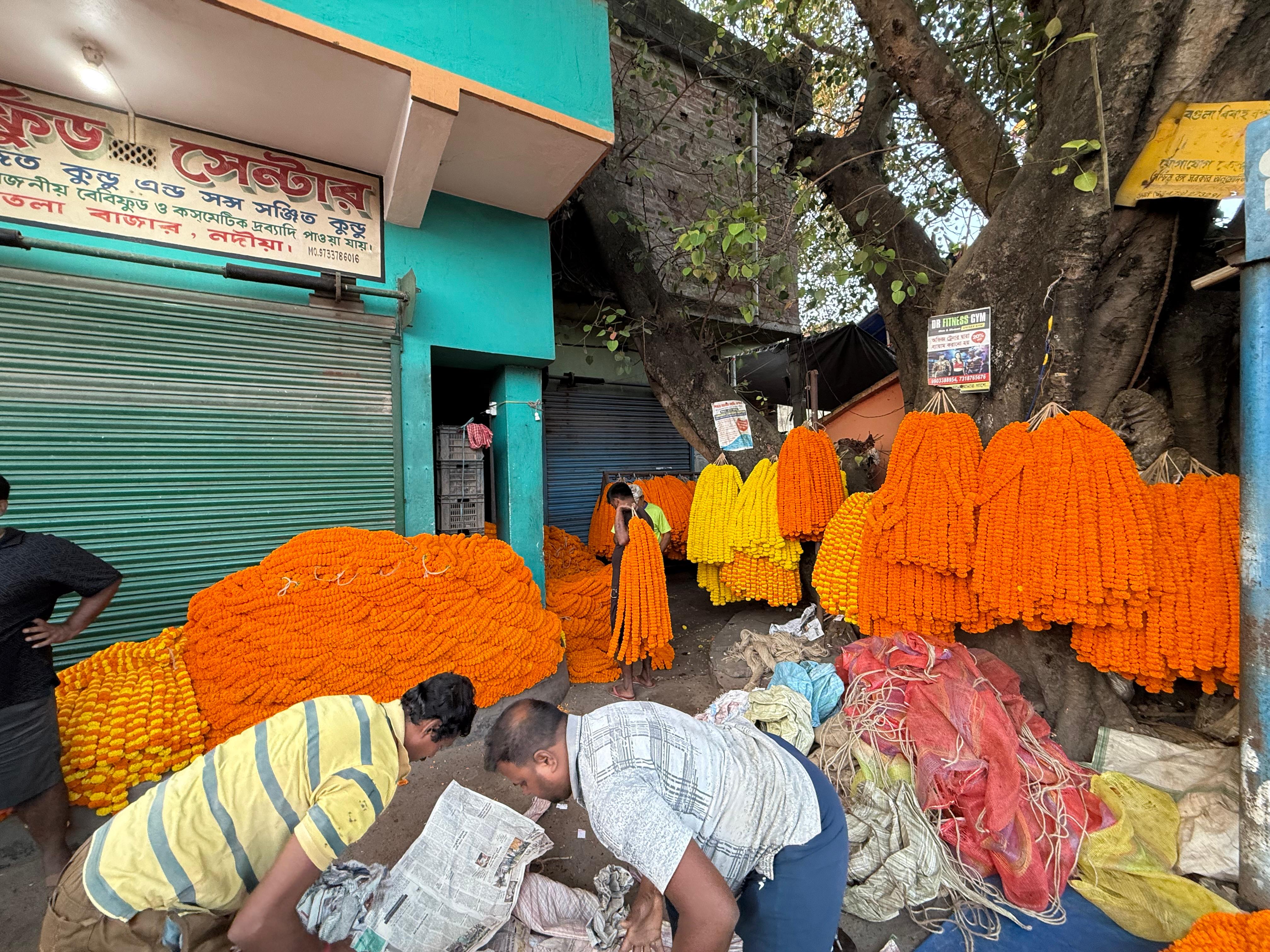 Vendors with marigold garlands at Dhantala flower mandi