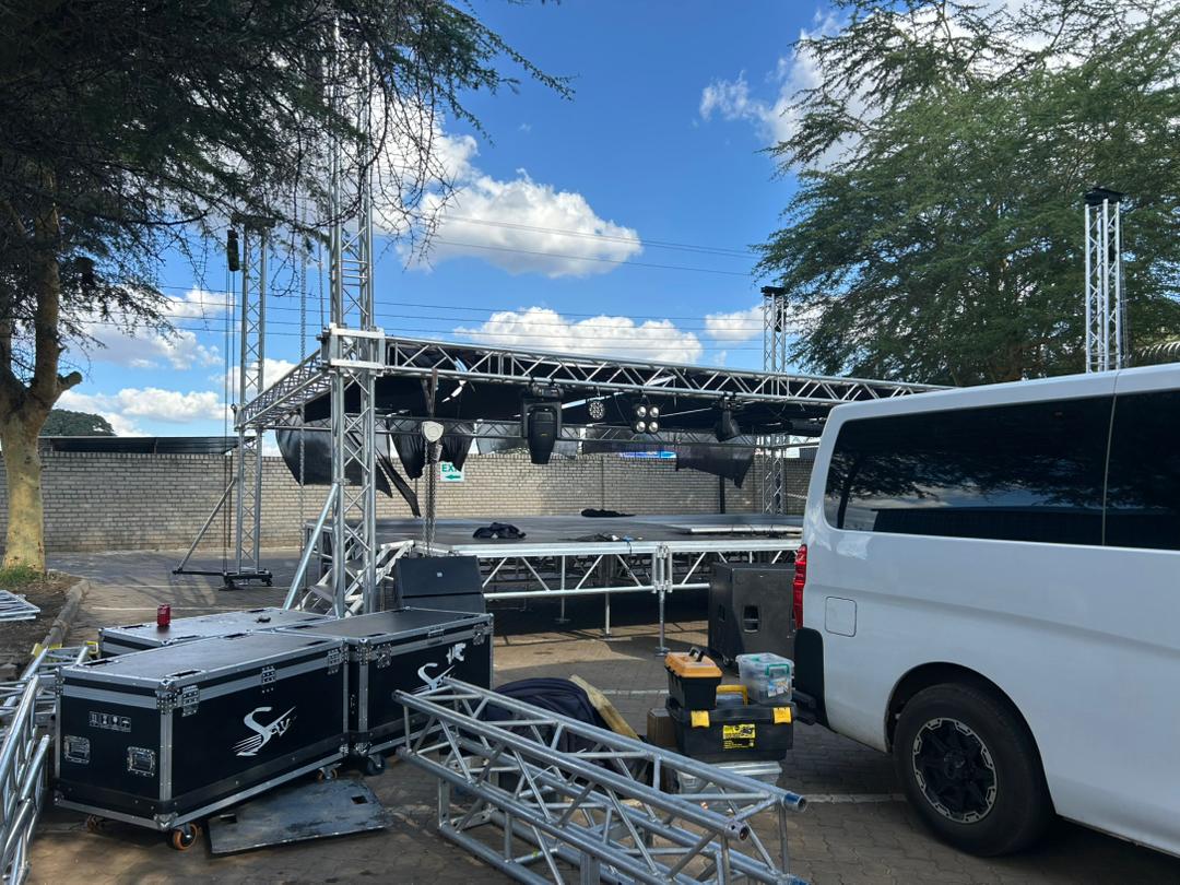 Professional outdoor staging setup with metal truss structure and lighting rigs