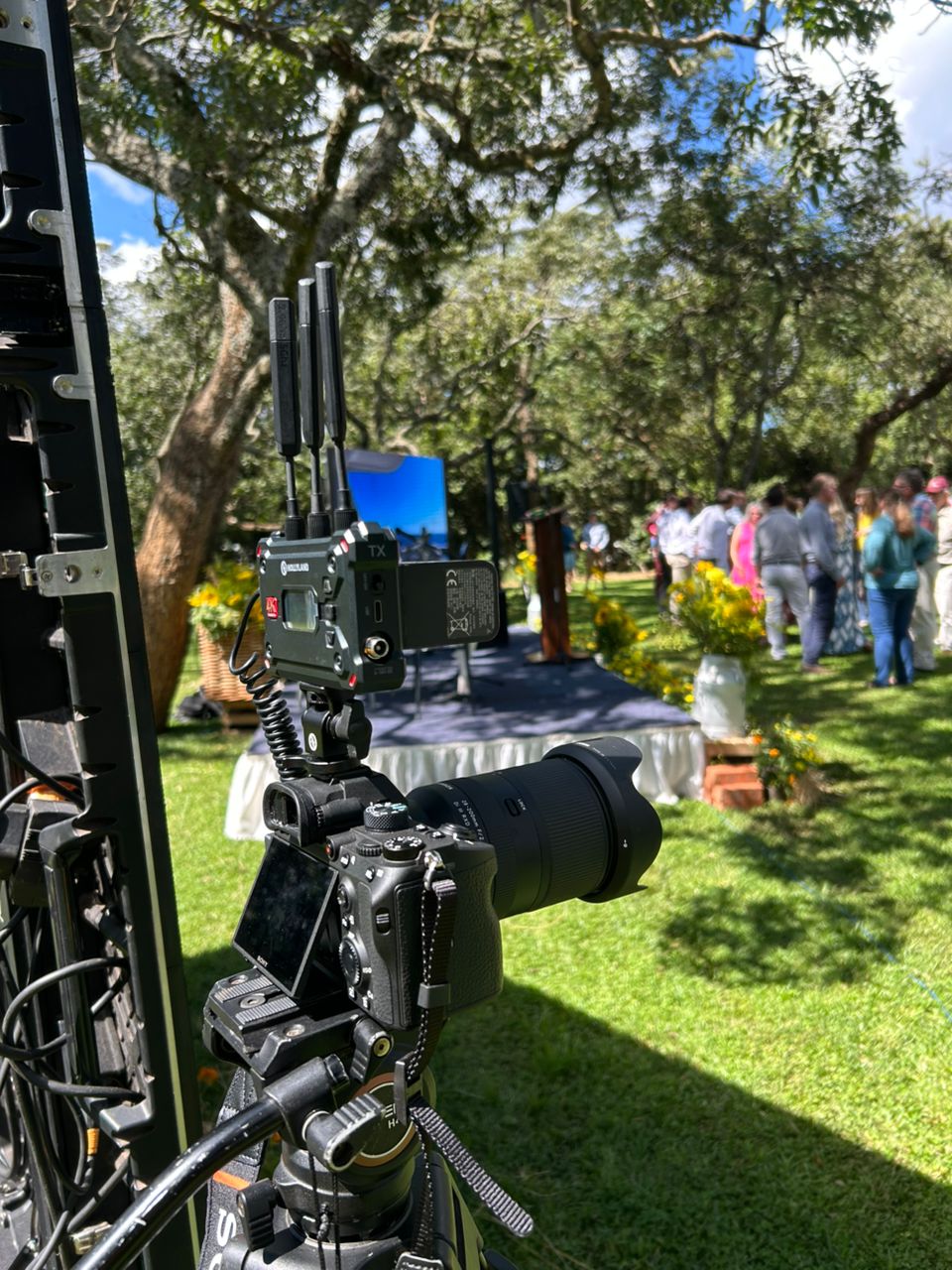 Professional cinema camera on tripod filming outdoor event production
