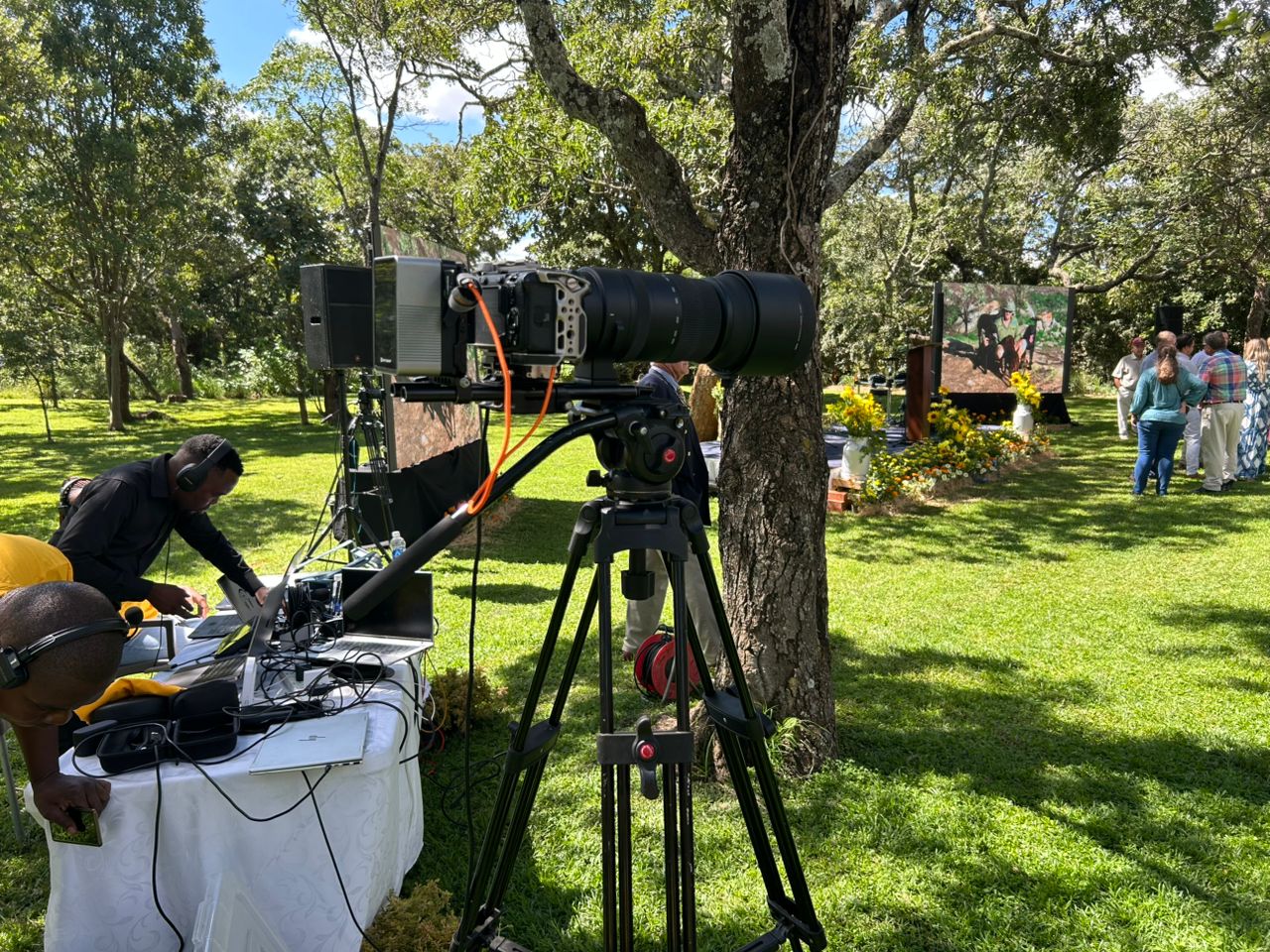 Professional videographer on location with cinema equipment and tripod setup