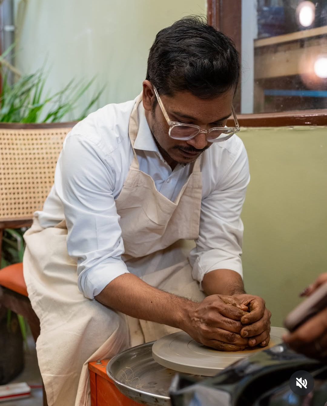 Artist centering clay at the pottery wheel