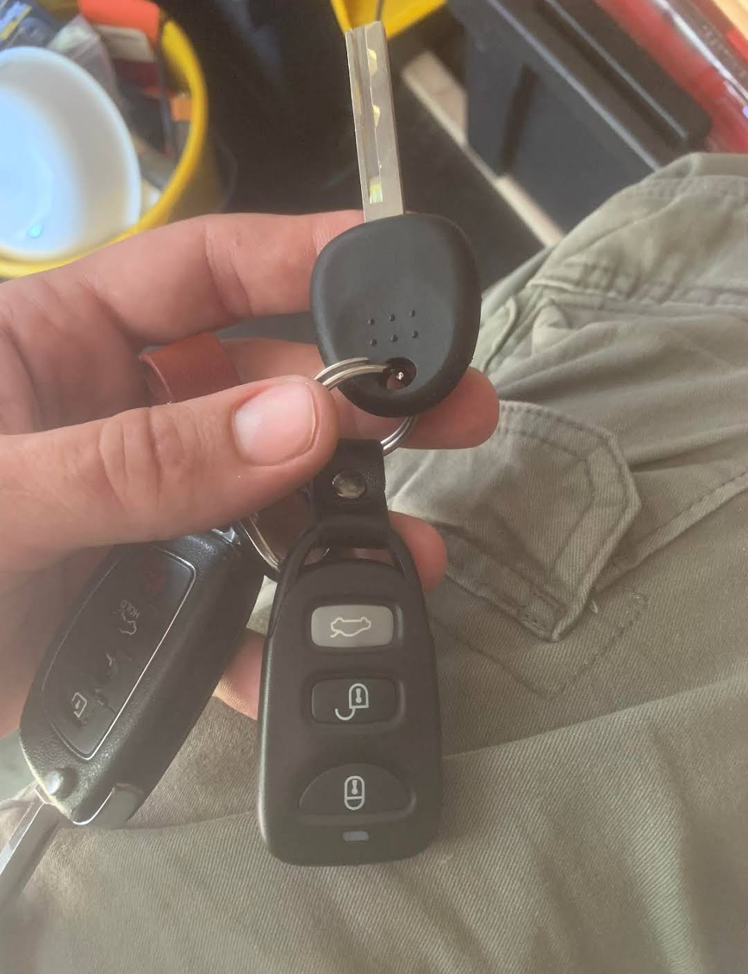 Hyundai and Kia transponder key and smart key fob being held