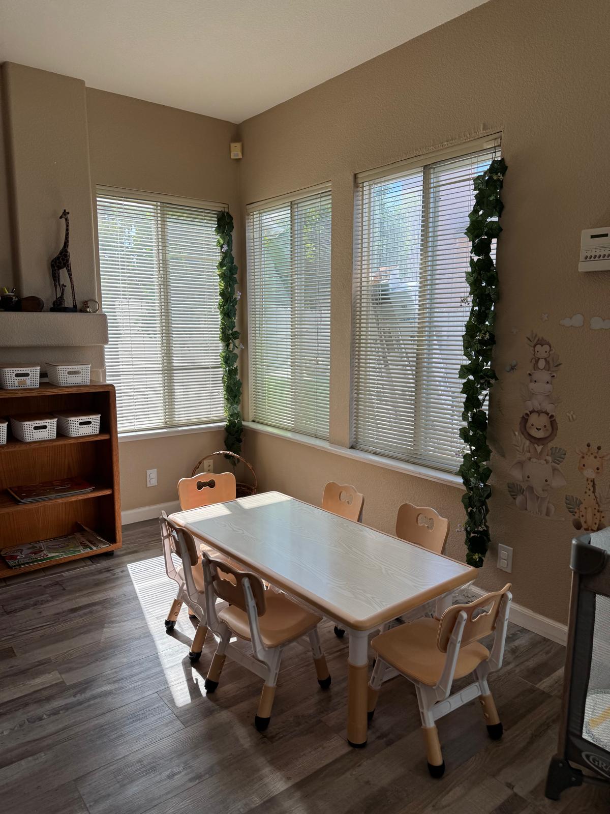 Children's activity table with chairs near sunlit windows