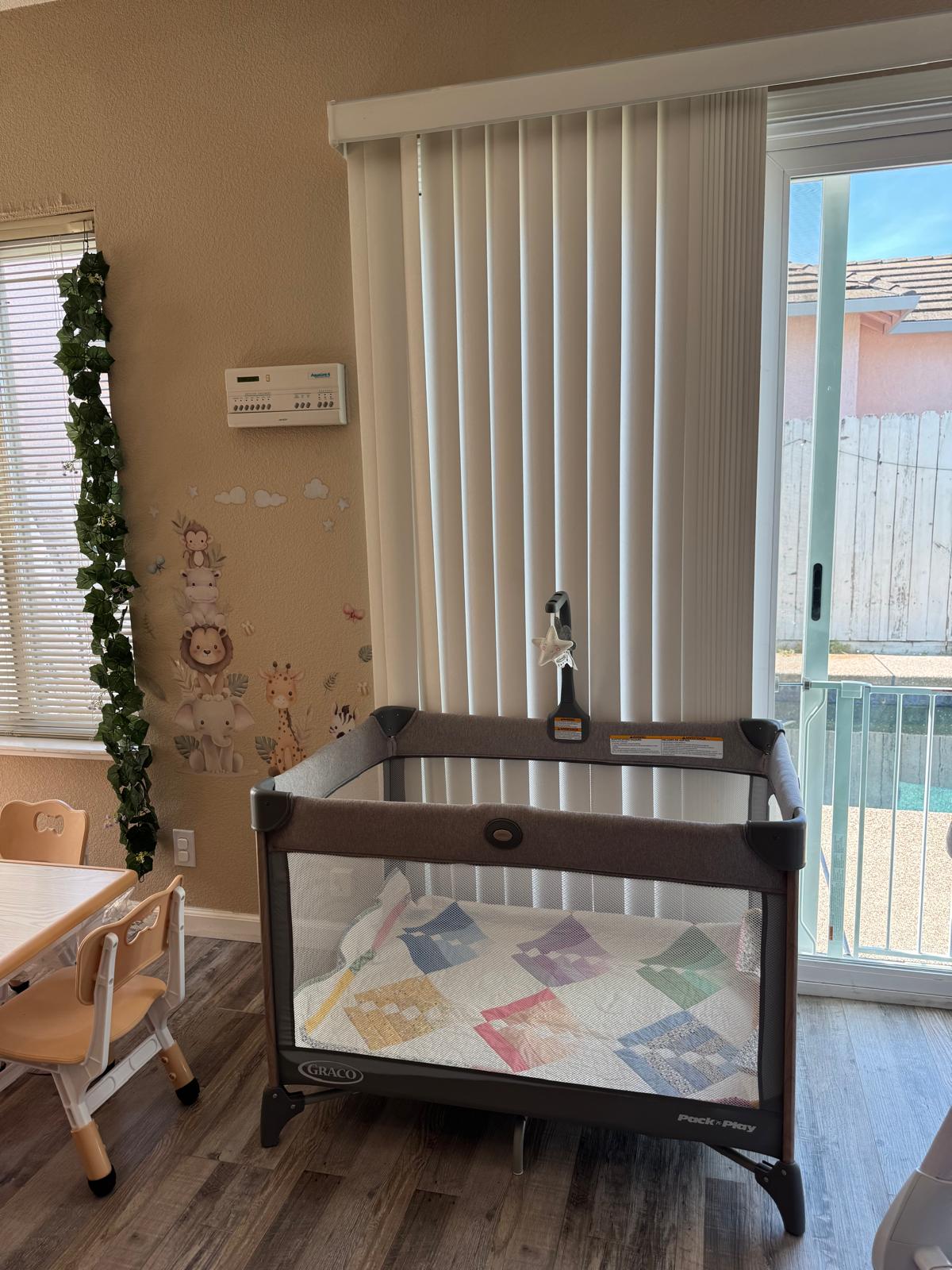 Crib by the window with safari wall decals