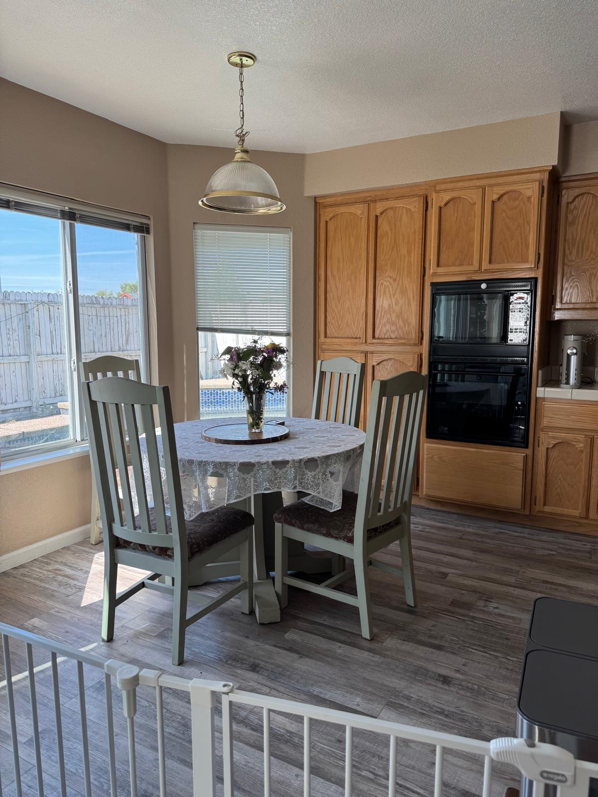 Bright dining nook with wooden table and flowers