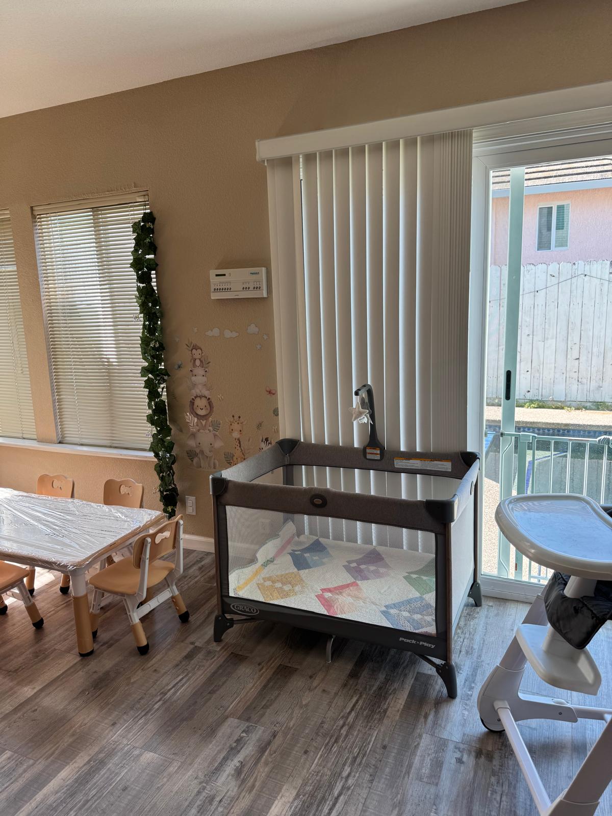 Quiet napping area with a Pack 'n Play crib and natural light