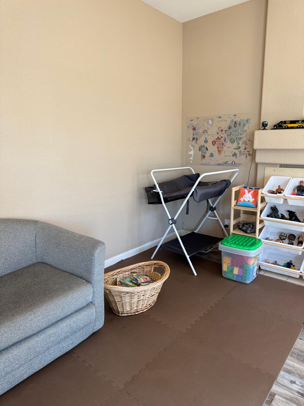 Quiet rest corner with a sofa, basket of books and a world map