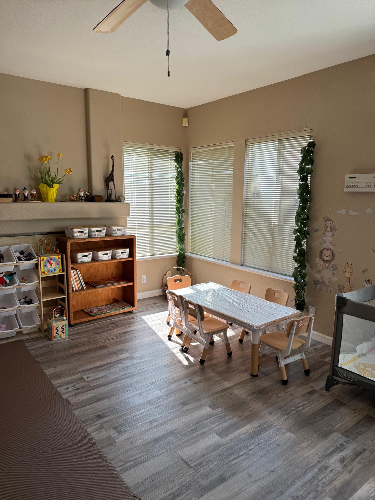 Children's activity table set up for art and play with bookshelf nearby