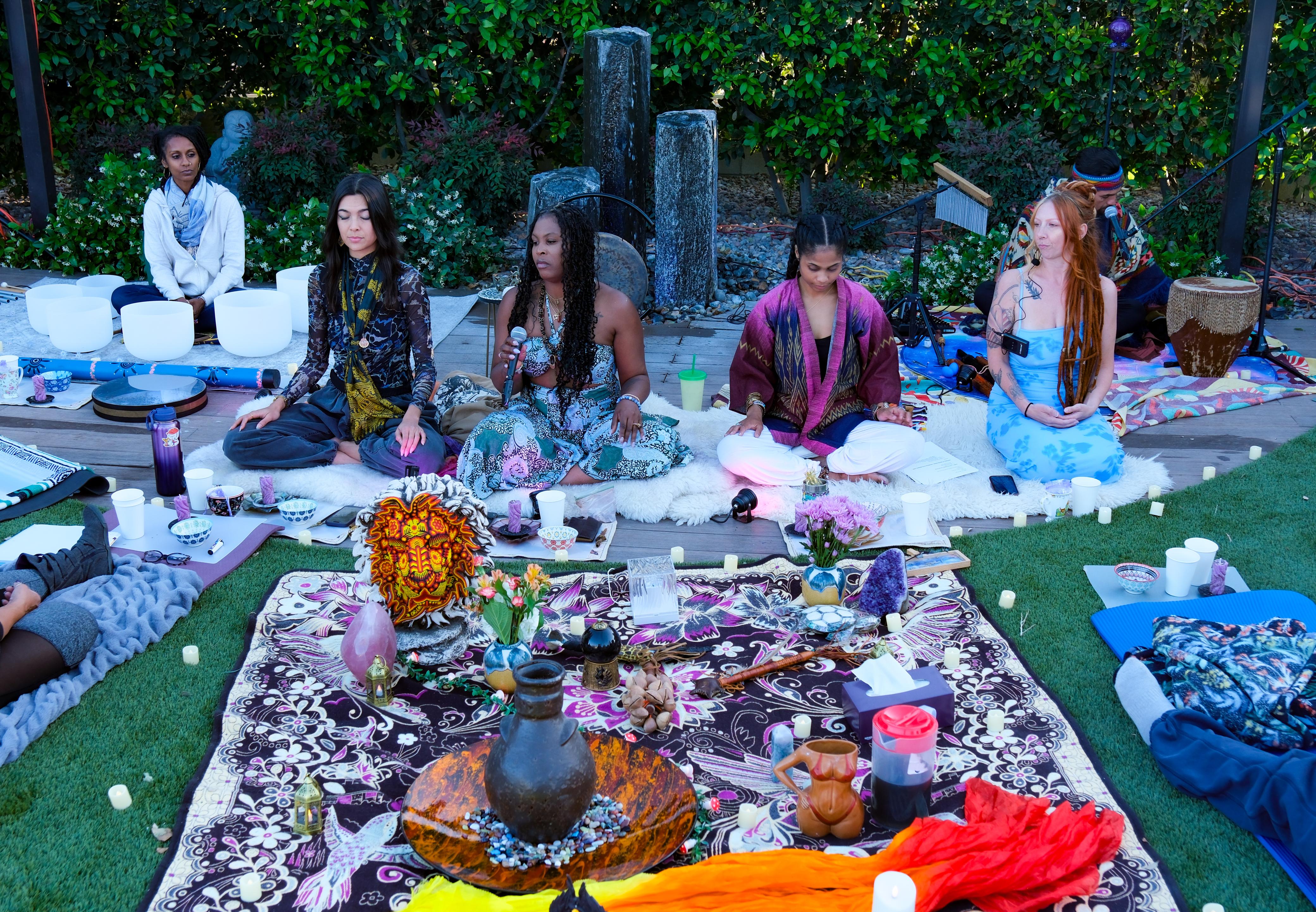 Circle of facilitators with crystals and sound bowls