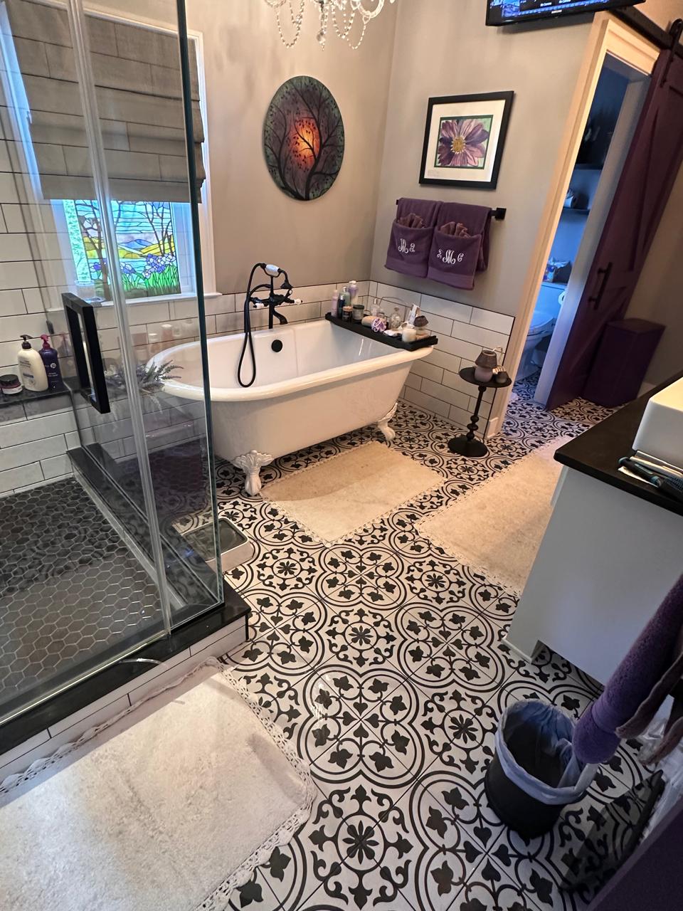 Elegant bathroom with decorative tile flooring and clawfoot tub