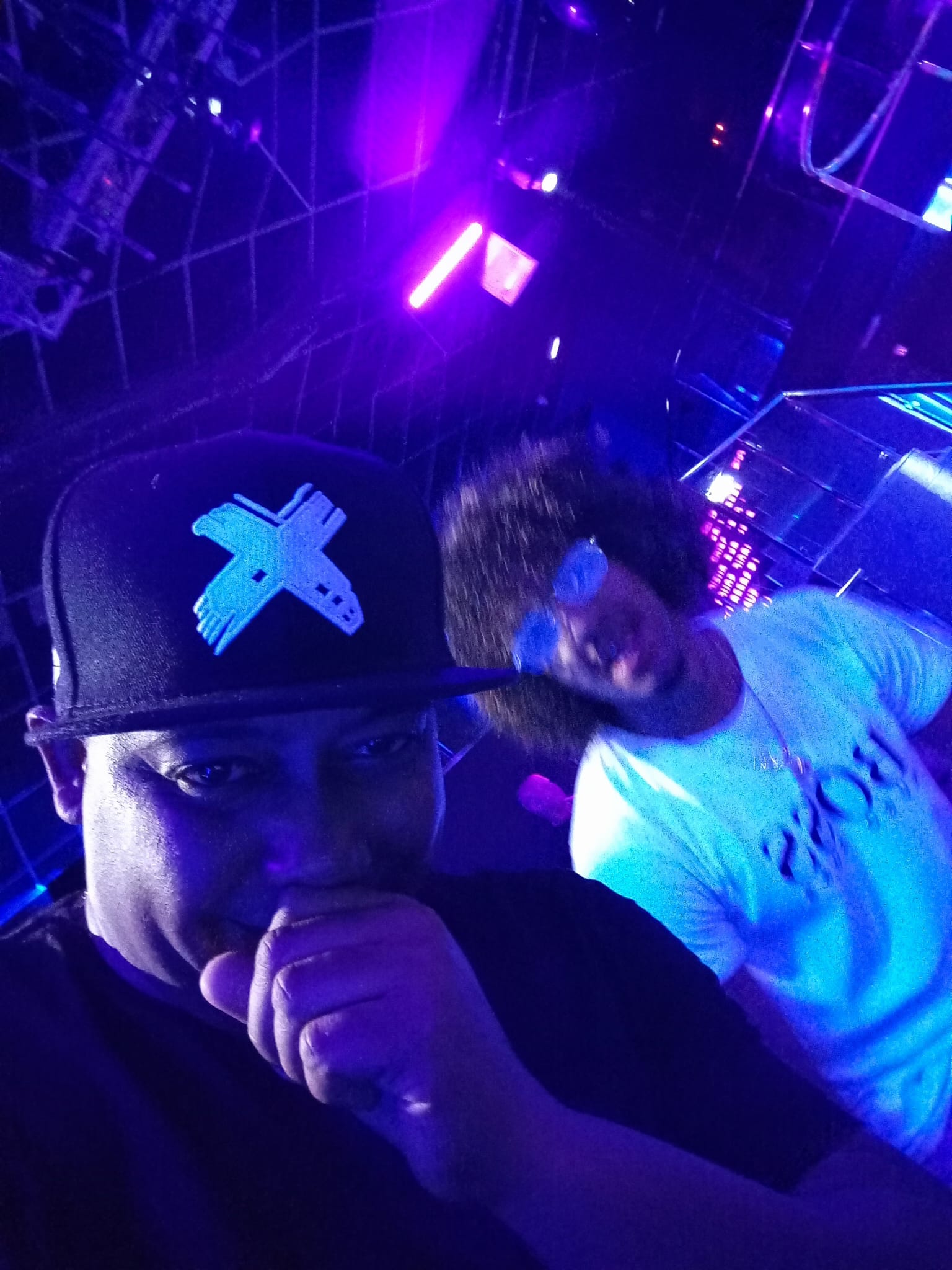 DJ JOHNX en club con luces azules