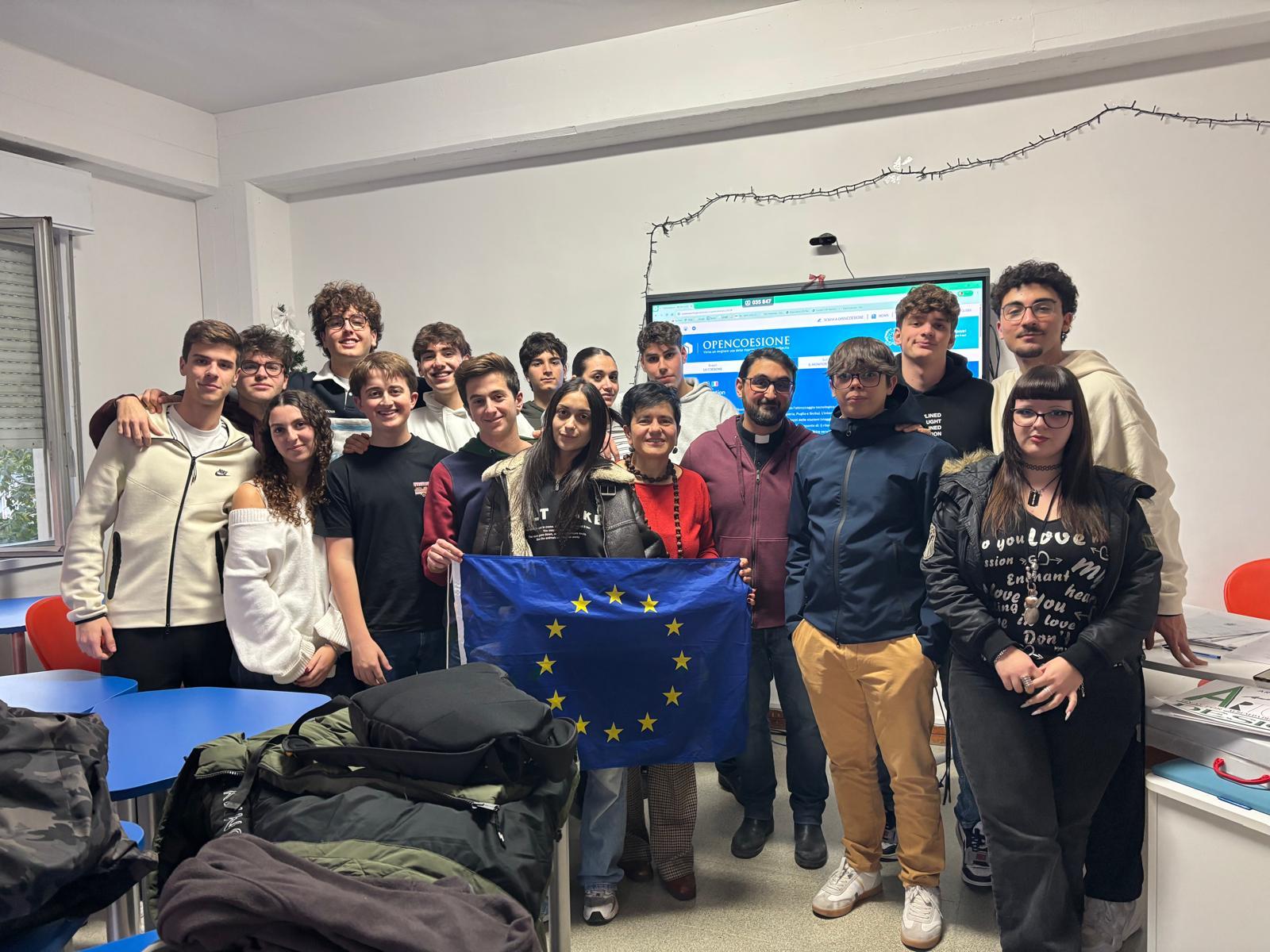R.A.I.L.S. team with EU flag in classroom with OpenCoesione presentation
