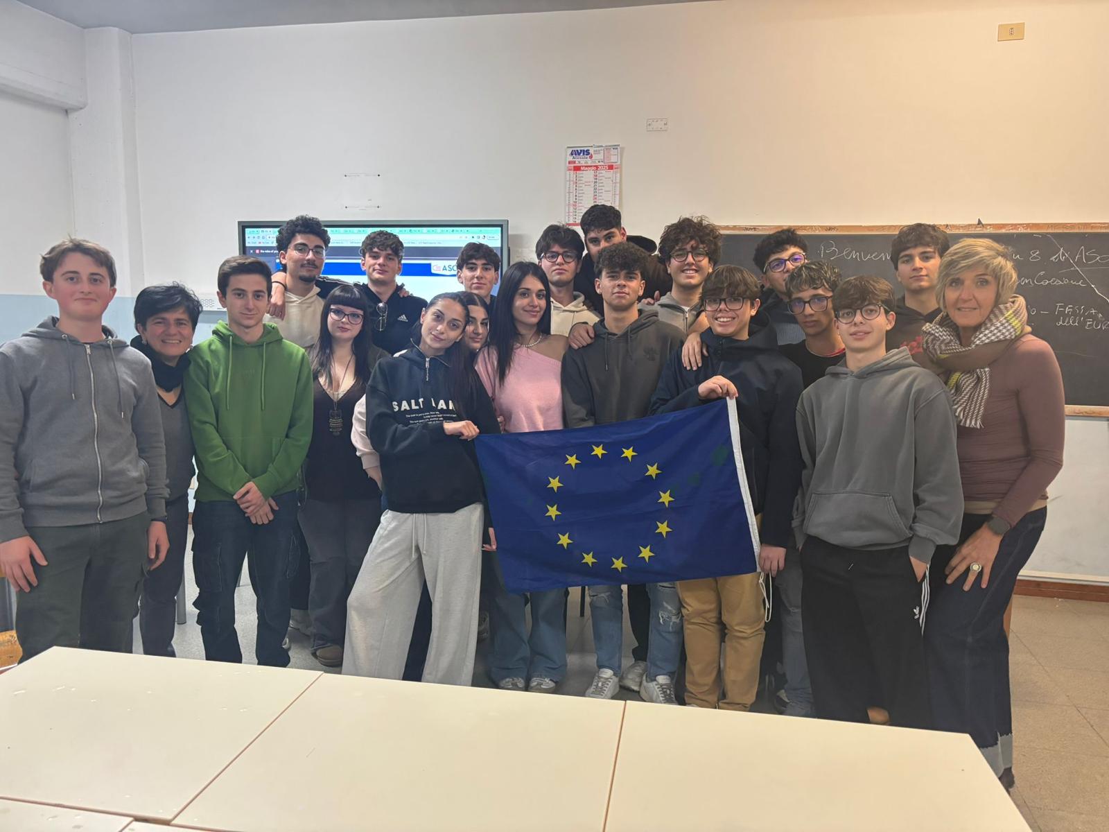 R.A.I.L.S. class group photo with EU flag in classroom