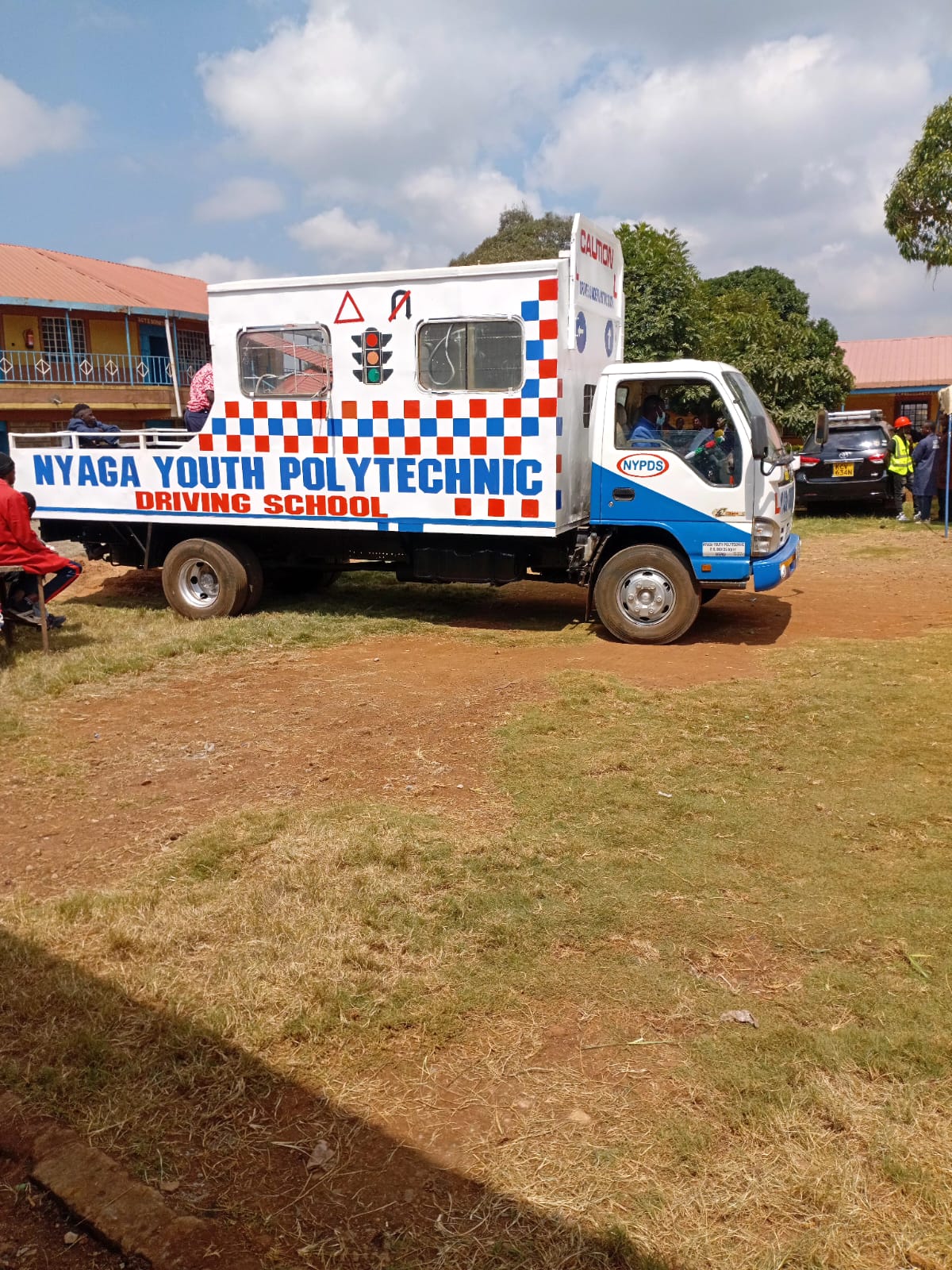 Nyaga Youth Polytechnic billboard on driving school truck