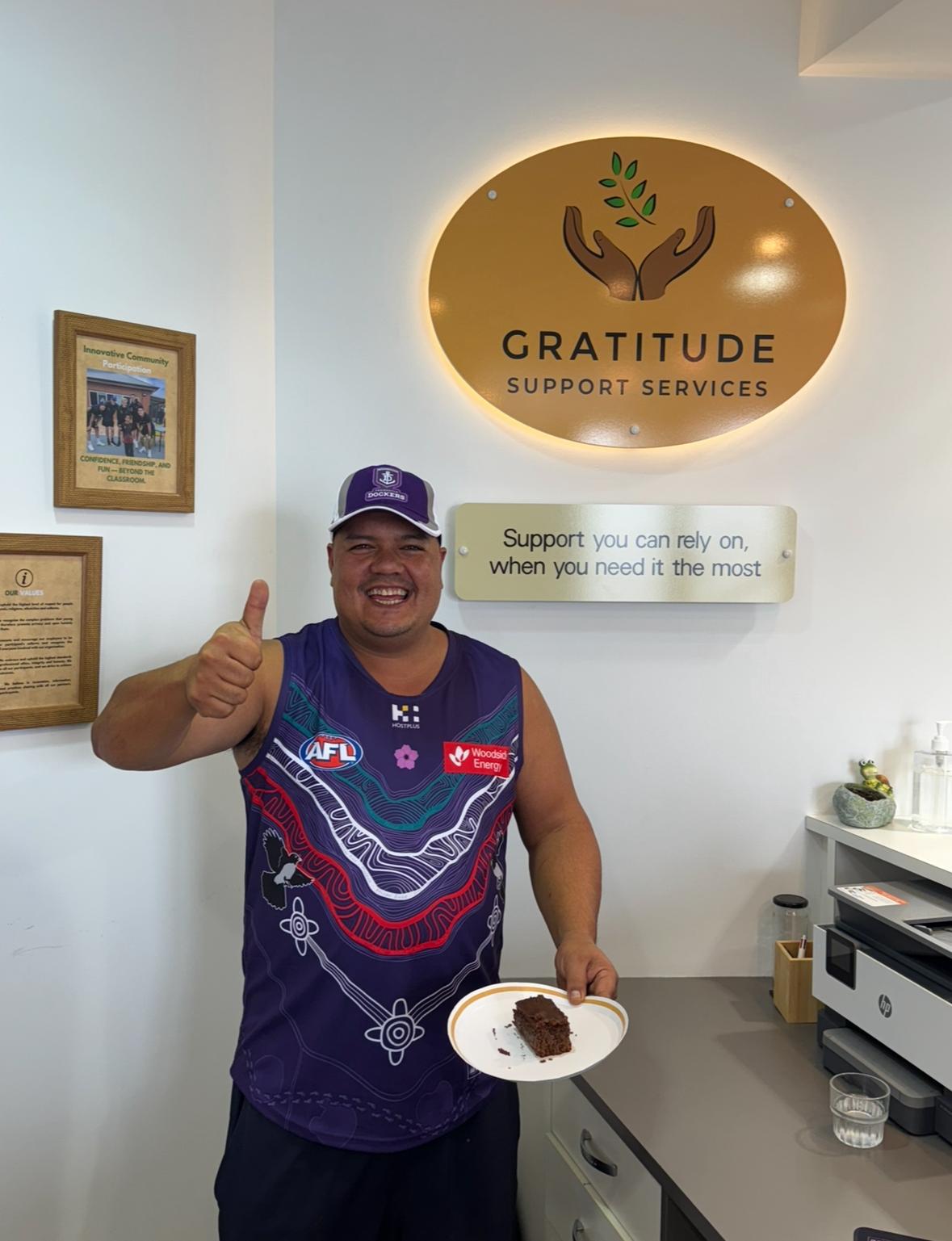 Participant at Gratitude office with thumbs up