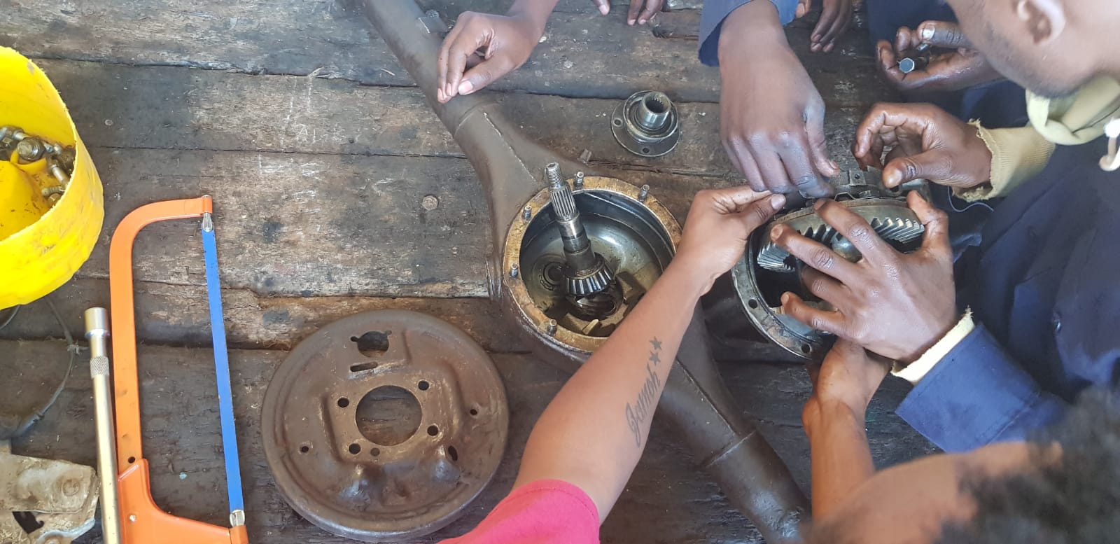 Motor vehicle mechanics students assembling a vehicle differential and axle