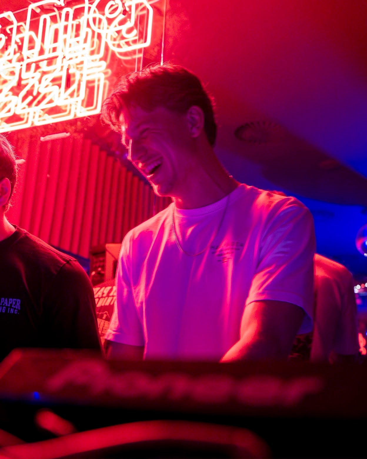DJ smiling under neon lights