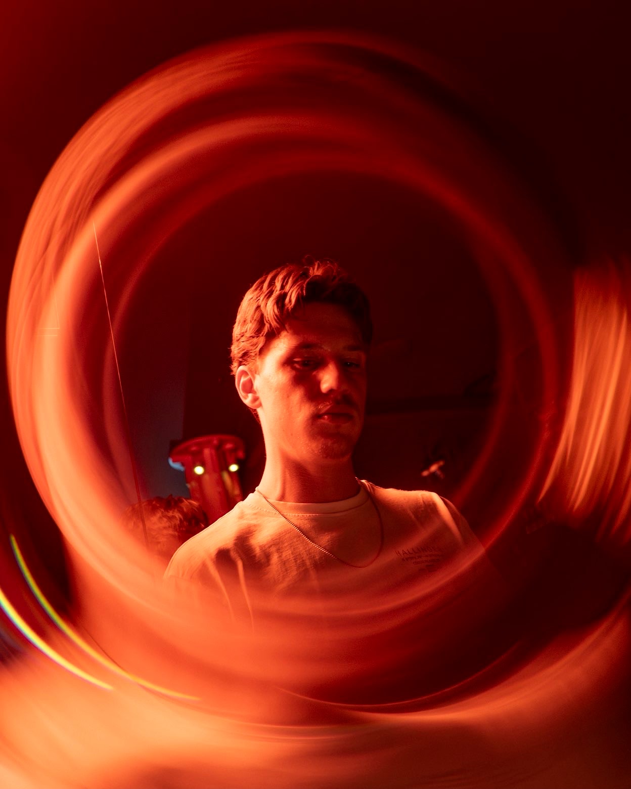 DJ surrounded by red light