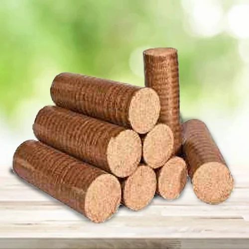 Stacked biomass briquettes on wooden surface