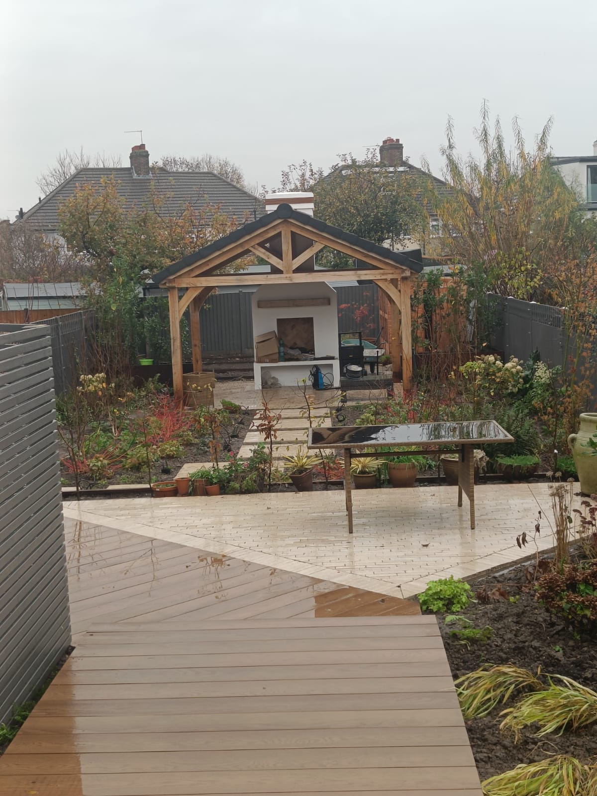 Oak-framed garden pavilion with a tiled roof and built-in fireplace
