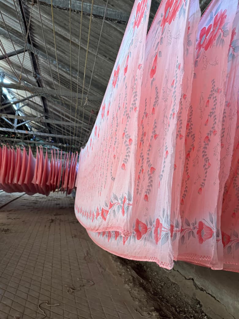 Freshly printed pink floral sarees hanging to dry in the A-1 Prints drying room, Goregaon East