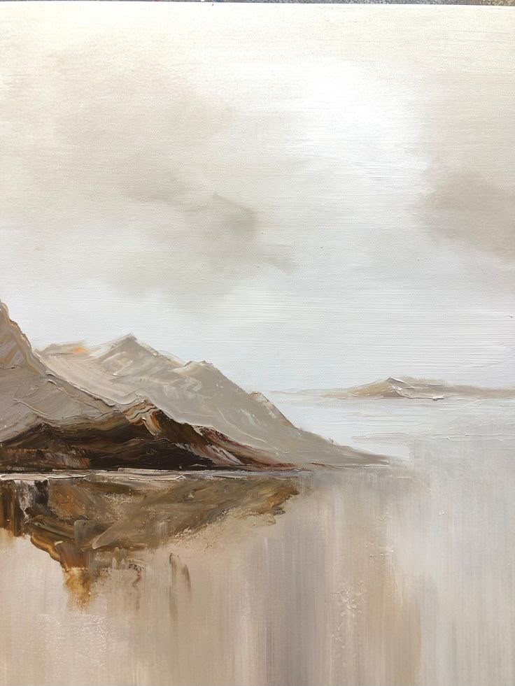 Misty mountain landscape reflected in still water in warm beige and gray tones