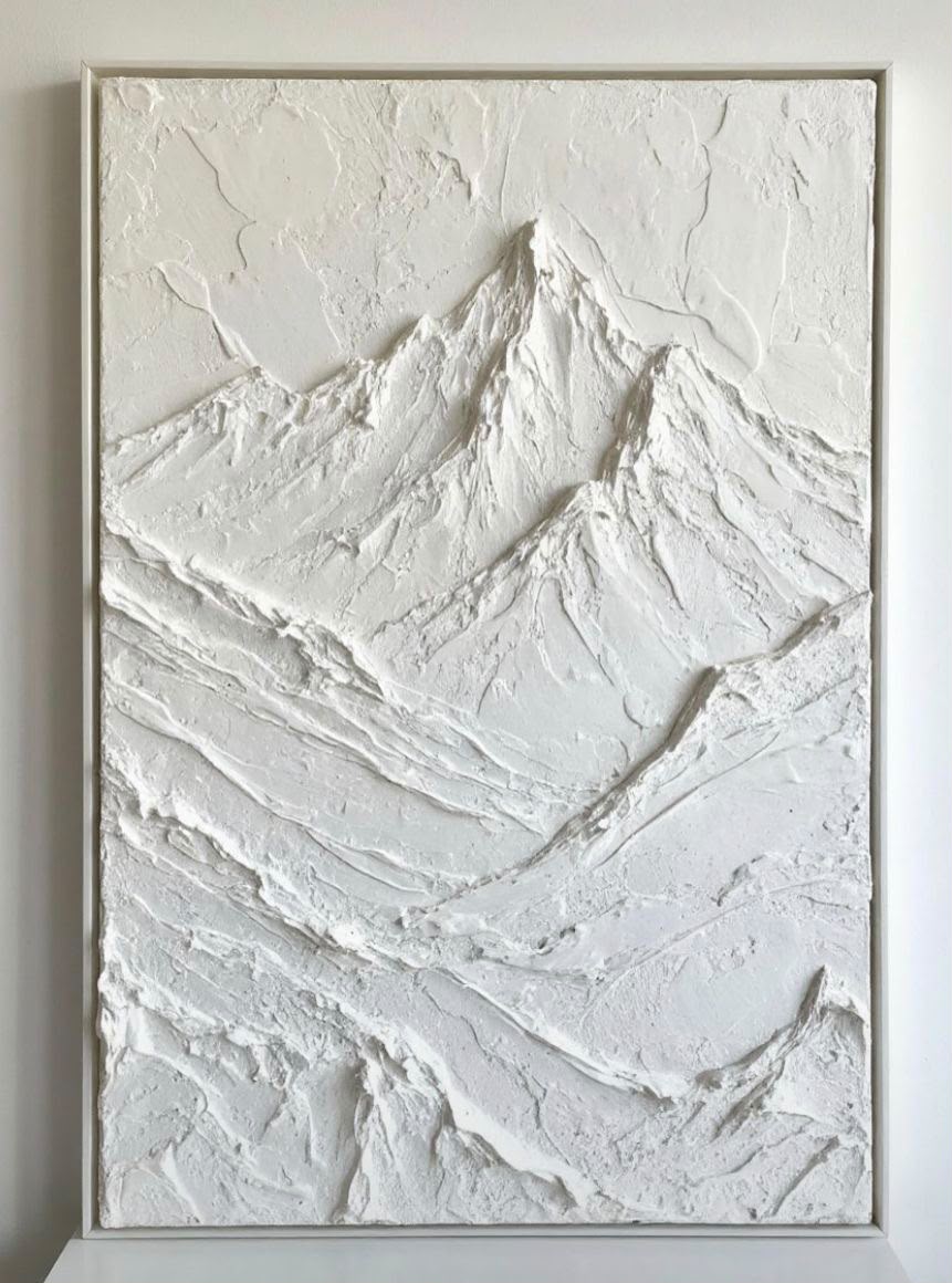 Pure white sculptural mountain relief painting, highly dimensional and framed in white
