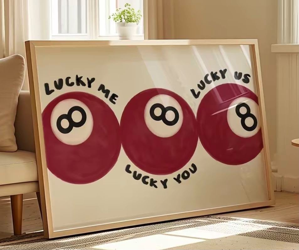 Three crimson billiard 8-balls with Lucky Me Lucky You Lucky Us written in playful handwritten lettering on a cream background