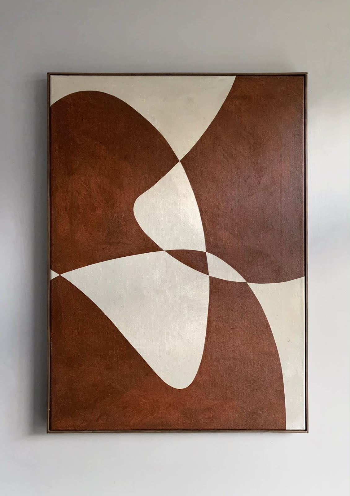 Terracotta brown and ivory biomorphic shapes forming a four-petal pinwheel composition on canvas