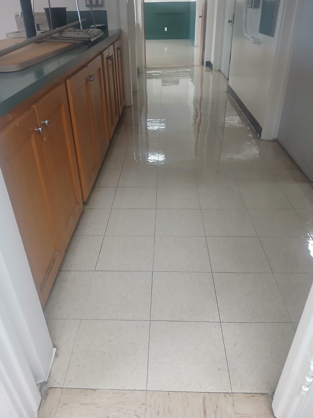 Long corridor with gleaming ceramic tiles and clean dark grout lines