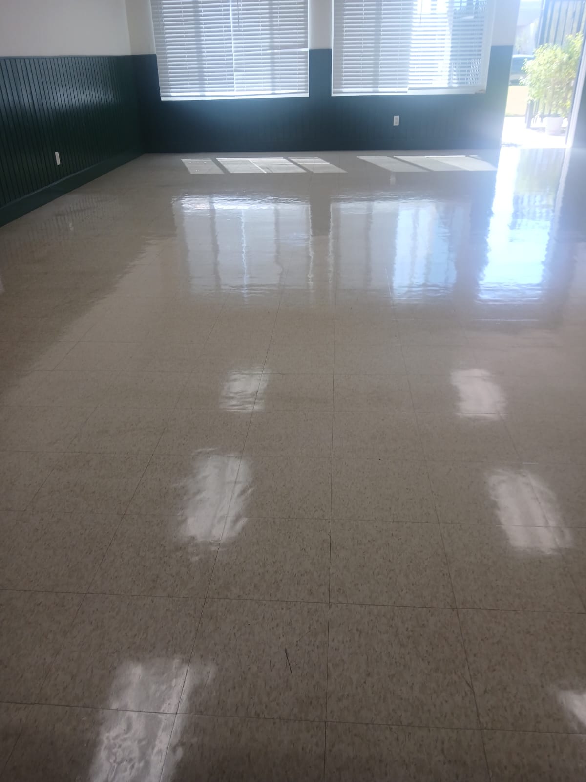 Large room with freshly stripped and waxed VCT floor — high gloss finish