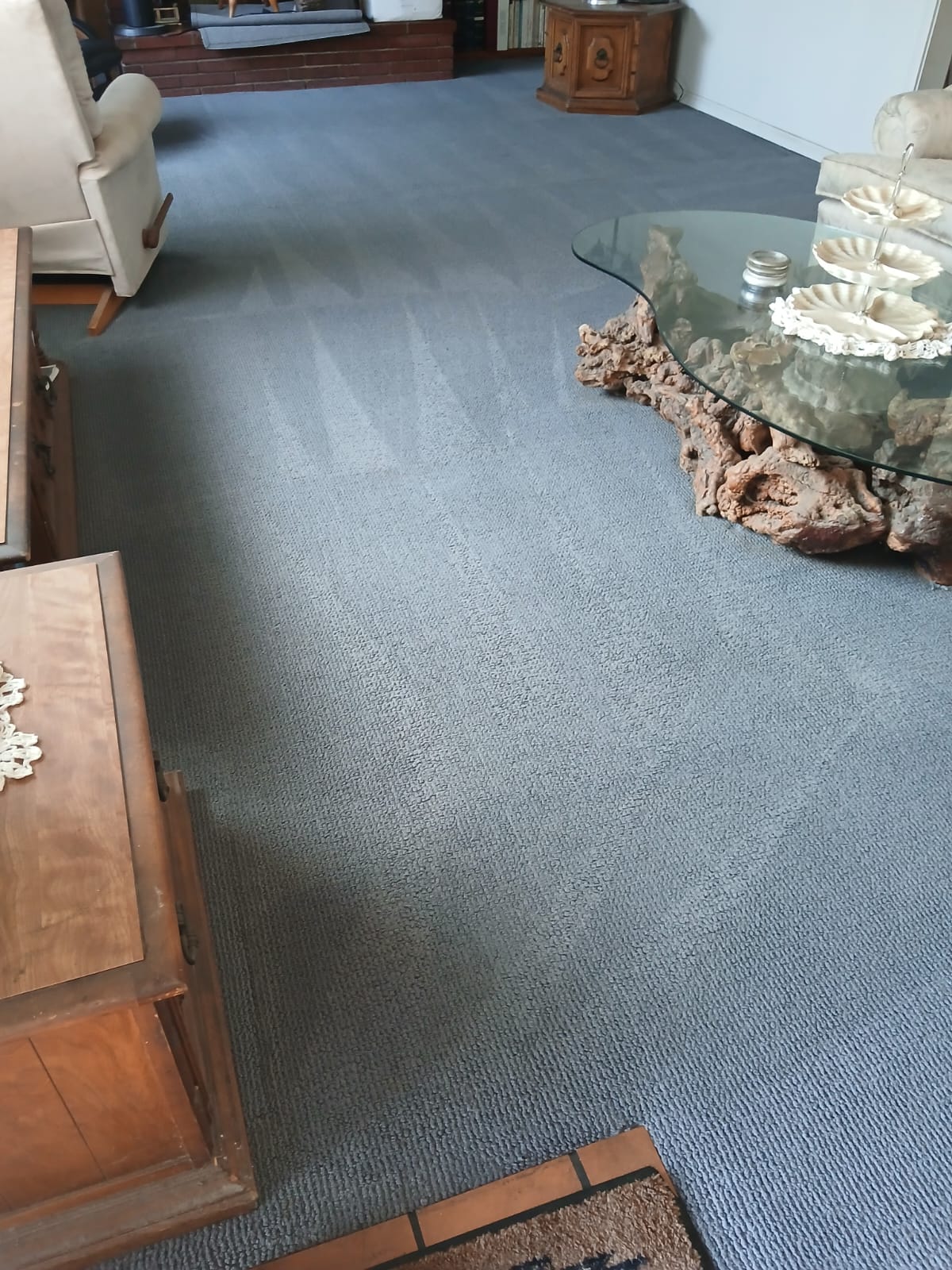 Gray carpet in furnished living room after professional steam cleaning