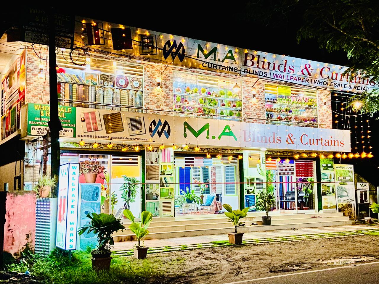 M.A Blinds & Curtains showroom exterior lit up at night with displays by M.A Blinds & Curtains