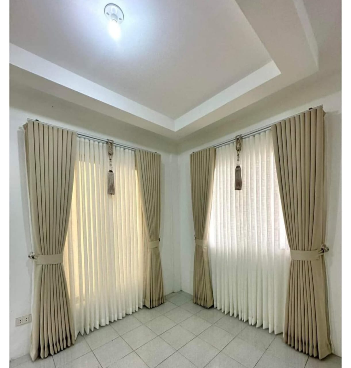 Elegant bedroom with cream curtains and decorative tassels by M.A Blinds & Curtains