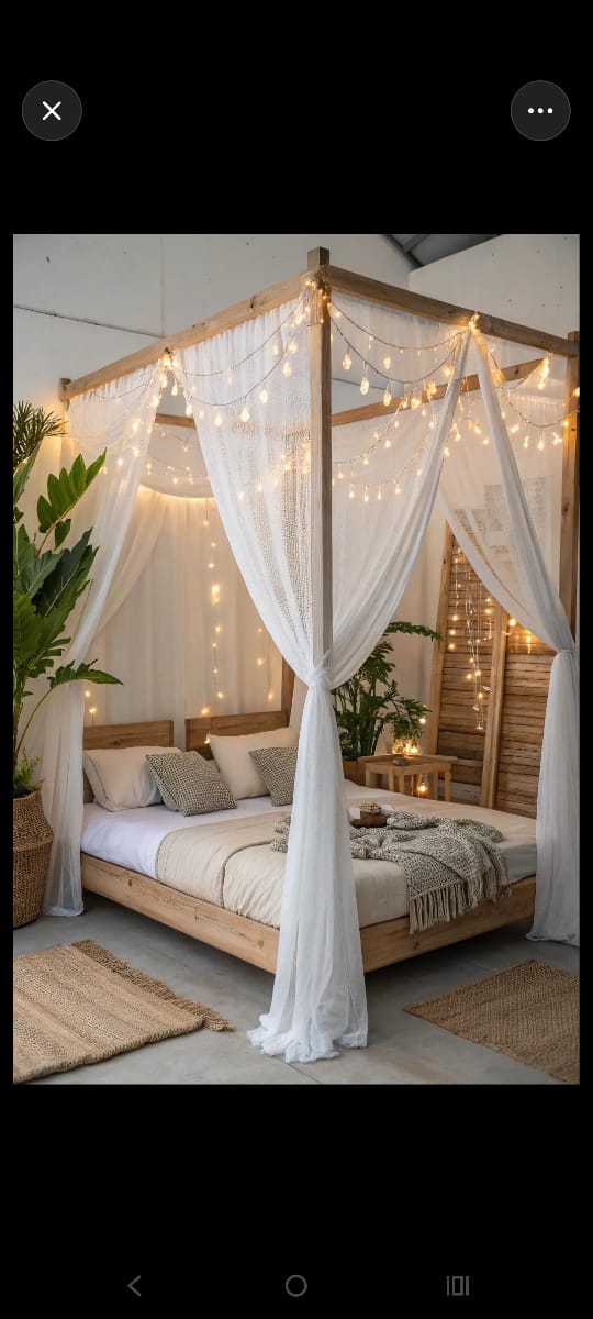 Decorative canopy bed with white sheer curtains and string lights by M.A Blinds & Curtains
